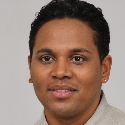Joyful black young-adult male with short  brown hair and brown eyes