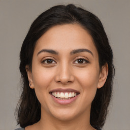 Joyful latino young-adult female with medium  brown hair and brown eyes