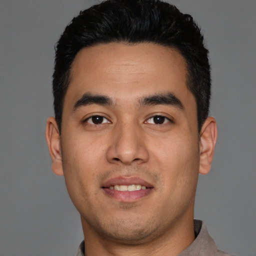 Joyful white young-adult male with short  black hair and brown eyes