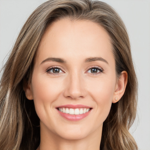 Joyful white young-adult female with long  brown hair and brown eyes