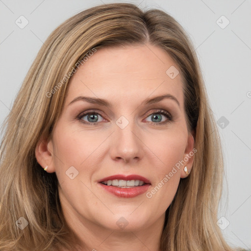 Joyful white adult female with long  brown hair and grey eyes