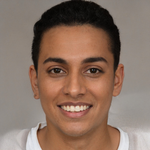 Joyful latino young-adult male with short  black hair and brown eyes