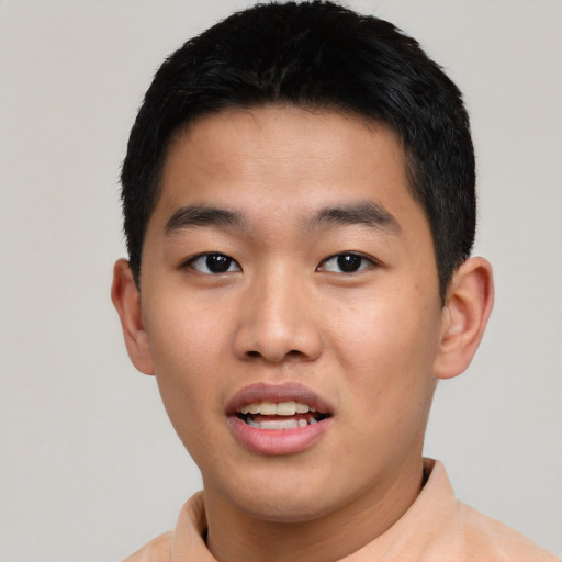 Joyful asian young-adult male with short  black hair and brown eyes