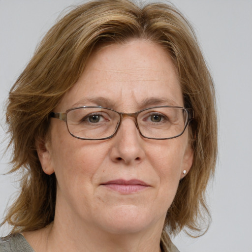 Joyful white middle-aged female with medium  brown hair and blue eyes