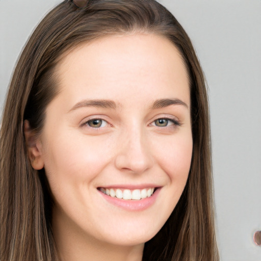 Joyful white young-adult female with long  brown hair and grey eyes