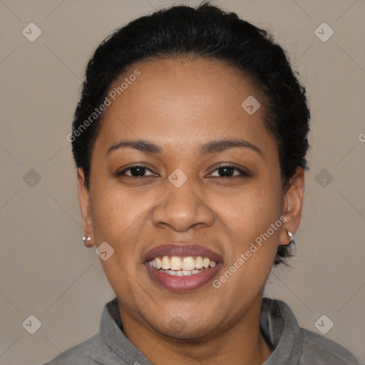 Joyful black adult female with short  black hair and brown eyes