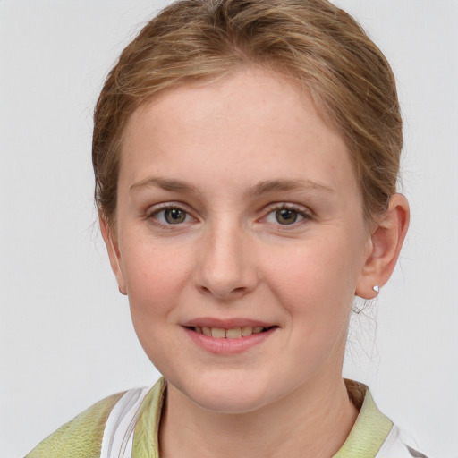 Joyful white young-adult female with short  brown hair and blue eyes