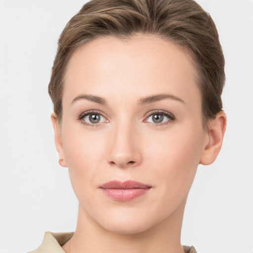 Joyful white young-adult female with short  brown hair and grey eyes