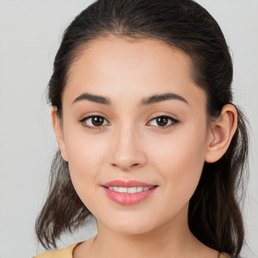 Joyful white young-adult female with long  brown hair and brown eyes