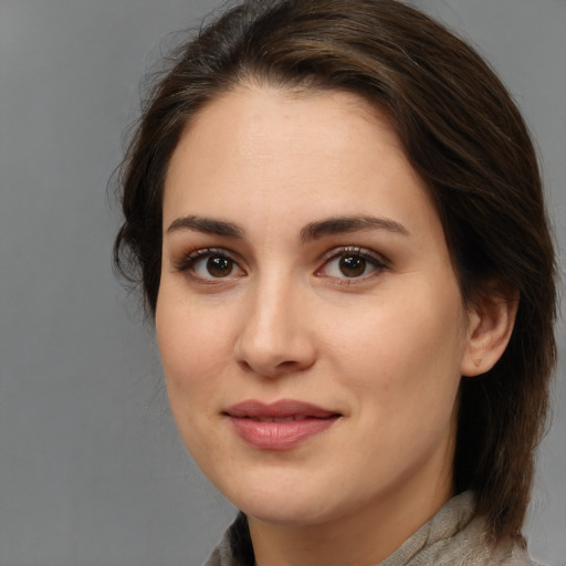 Joyful white young-adult female with medium  brown hair and brown eyes