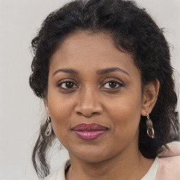 Joyful black adult female with medium  brown hair and brown eyes