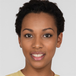 Joyful black young-adult female with short  black hair and brown eyes