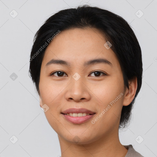 Joyful asian young-adult female with short  black hair and brown eyes