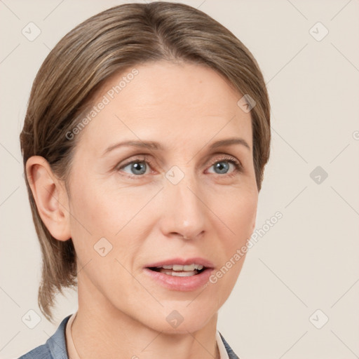 Joyful white adult female with medium  brown hair and grey eyes