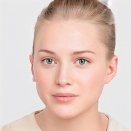 Joyful white young-adult female with short  brown hair and blue eyes