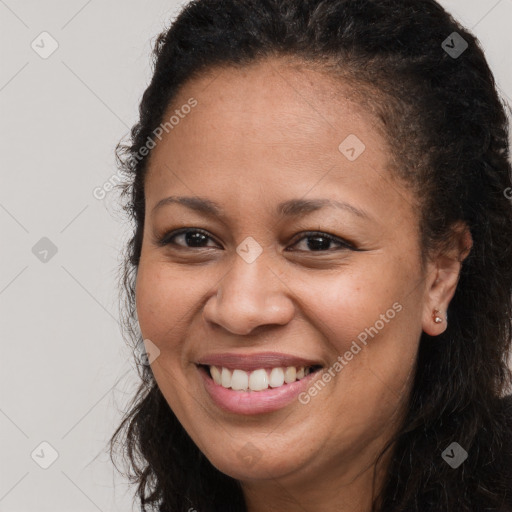 Joyful latino young-adult female with long  brown hair and brown eyes