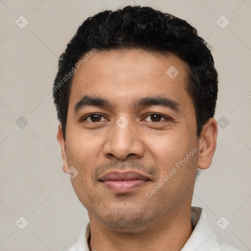 Joyful latino young-adult male with short  black hair and brown eyes