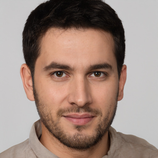 Joyful white young-adult male with short  brown hair and brown eyes