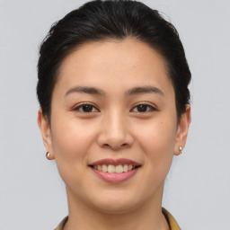 Joyful asian young-adult female with short  brown hair and brown eyes