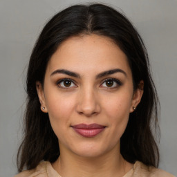 Joyful latino young-adult female with medium  brown hair and brown eyes