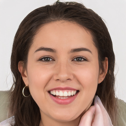 Joyful white young-adult female with long  brown hair and brown eyes