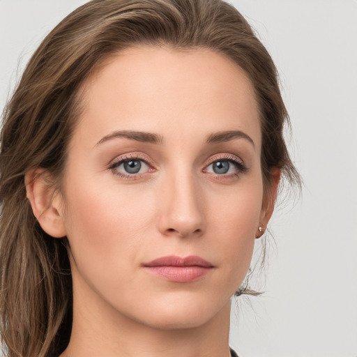 Joyful white young-adult female with long  brown hair and grey eyes