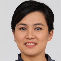 Joyful asian young-adult female with short  black hair and brown eyes
