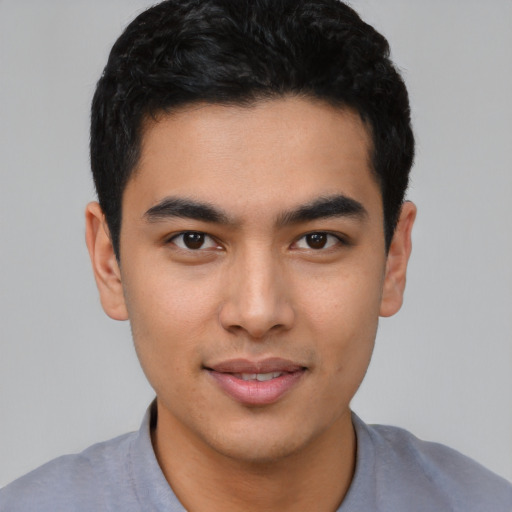 Joyful asian young-adult male with short  black hair and brown eyes