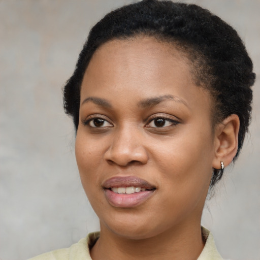 Joyful black young-adult female with short  brown hair and brown eyes