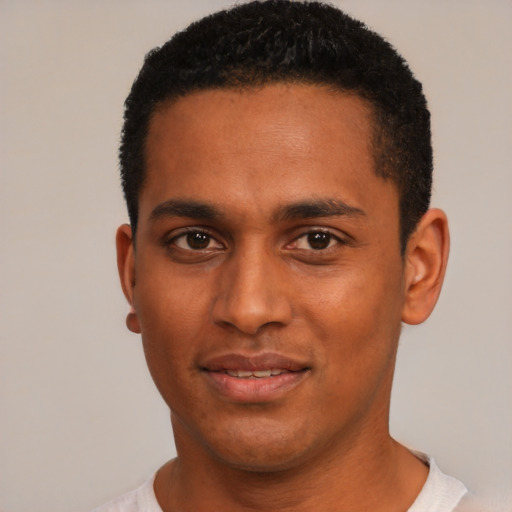 Joyful black young-adult male with short  black hair and brown eyes