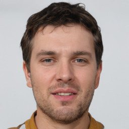 Joyful white young-adult male with short  brown hair and brown eyes