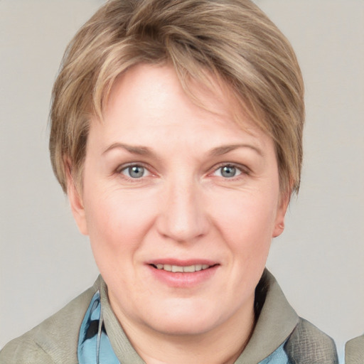 Joyful white adult female with medium  brown hair and blue eyes