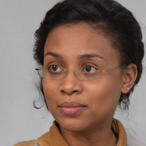 Joyful black young-adult female with medium  brown hair and brown eyes