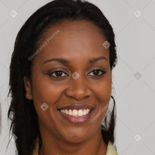 Joyful black young-adult female with long  brown hair and brown eyes