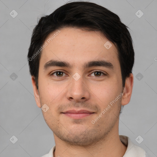 Joyful white young-adult male with short  black hair and brown eyes