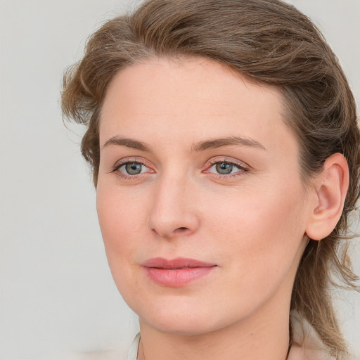 Joyful white young-adult female with medium  brown hair and blue eyes