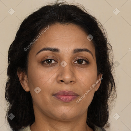 Joyful latino adult female with medium  brown hair and brown eyes