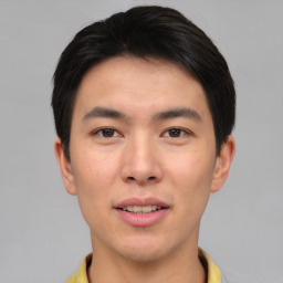 Joyful asian young-adult male with short  brown hair and brown eyes