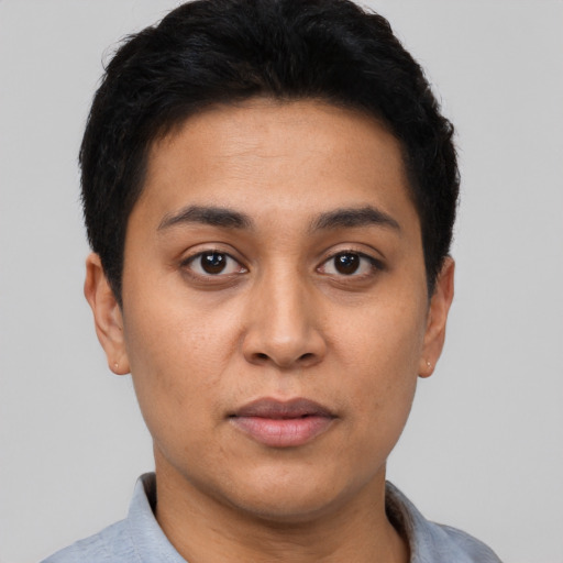 Joyful latino young-adult male with short  black hair and brown eyes