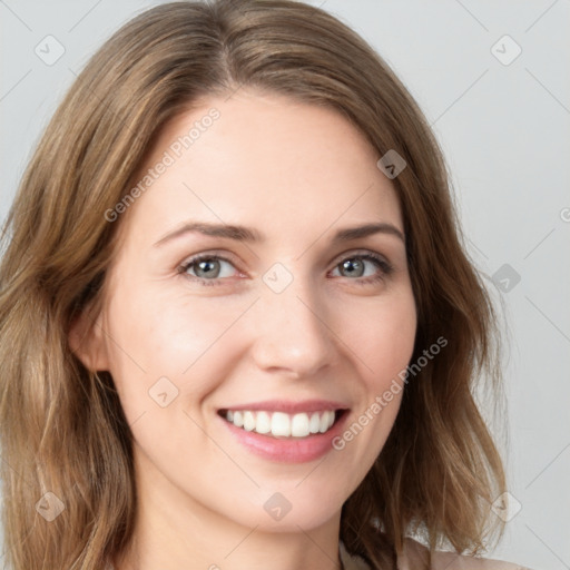 Joyful white young-adult female with long  brown hair and green eyes