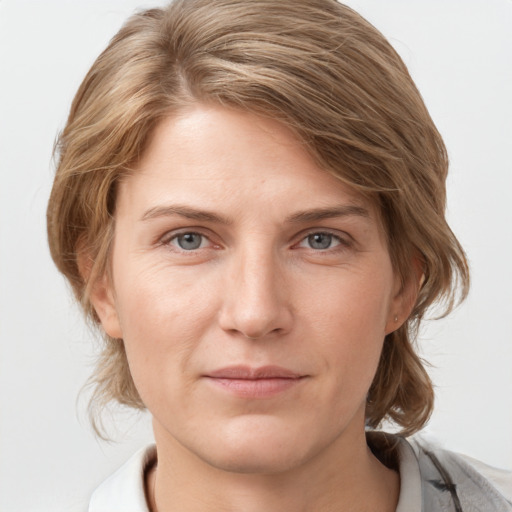 Joyful white young-adult female with medium  brown hair and blue eyes