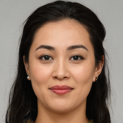 Joyful asian young-adult female with long  brown hair and brown eyes