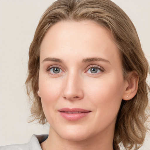 Joyful white young-adult female with medium  brown hair and blue eyes