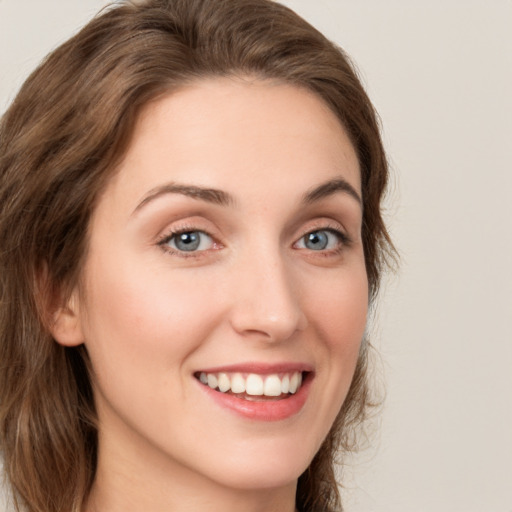 Joyful white young-adult female with medium  brown hair and green eyes