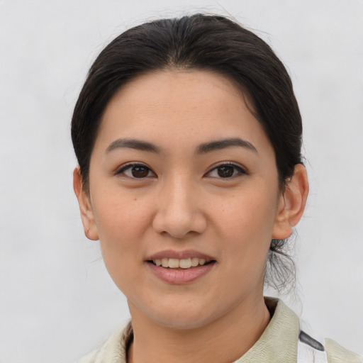 Joyful asian young-adult female with medium  brown hair and brown eyes