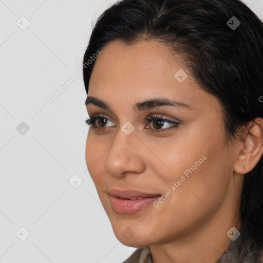 Joyful latino young-adult female with long  brown hair and brown eyes