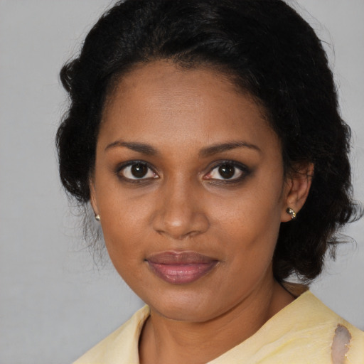 Joyful black young-adult female with medium  brown hair and brown eyes