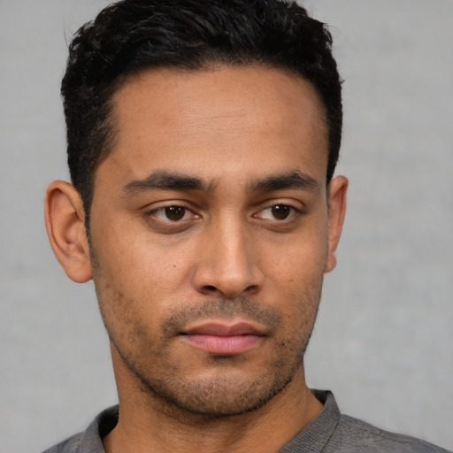 Neutral latino young-adult male with short  black hair and brown eyes