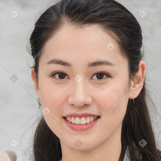 Joyful white young-adult female with long  brown hair and brown eyes