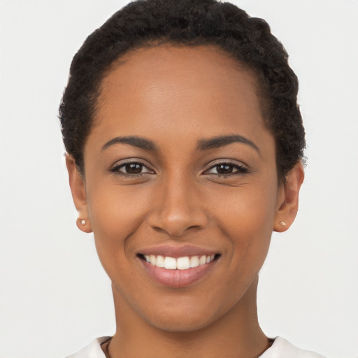 Joyful latino young-adult female with short  brown hair and brown eyes